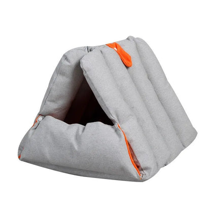 Blue triangular cotton cat bed with a removable cover on a wooden floor.