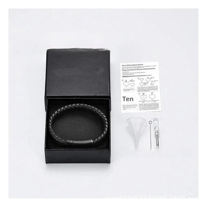 Black leather and stainless steel men's casket bracelet with engraved letters in a woven design.