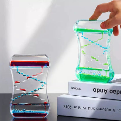 Creative Cruise Fluid Liquid Hourglass Timer with blue and pink liquid on desk