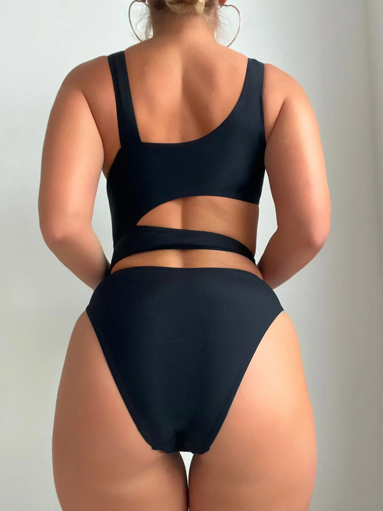 Black high-cut women's one-piece swimsuit with sleeveless design