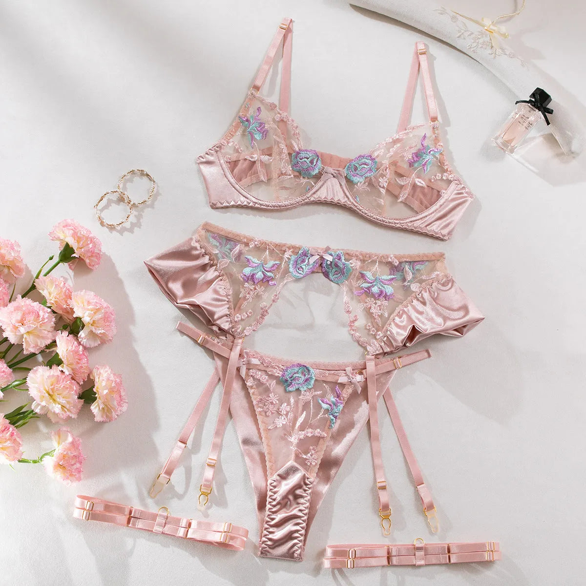 Light purple satin four-piece lingerie set with embroidery on a hanger