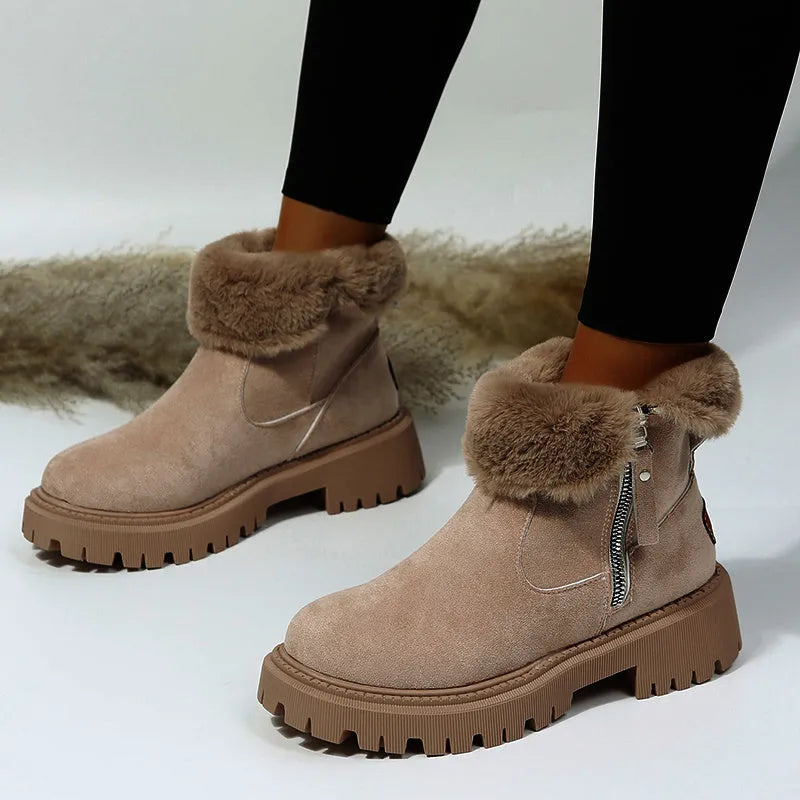 Women's black high top snow boots with a faux suede upper and side zipper on a white background.