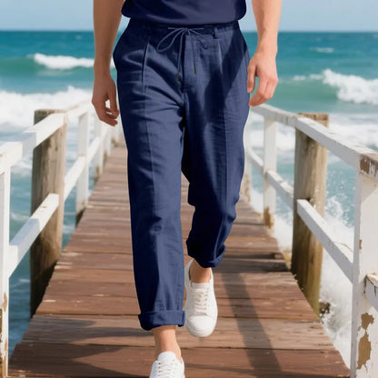 Men's light beige linen trousers with a loose straight leg and drawstring waist on a hanger.