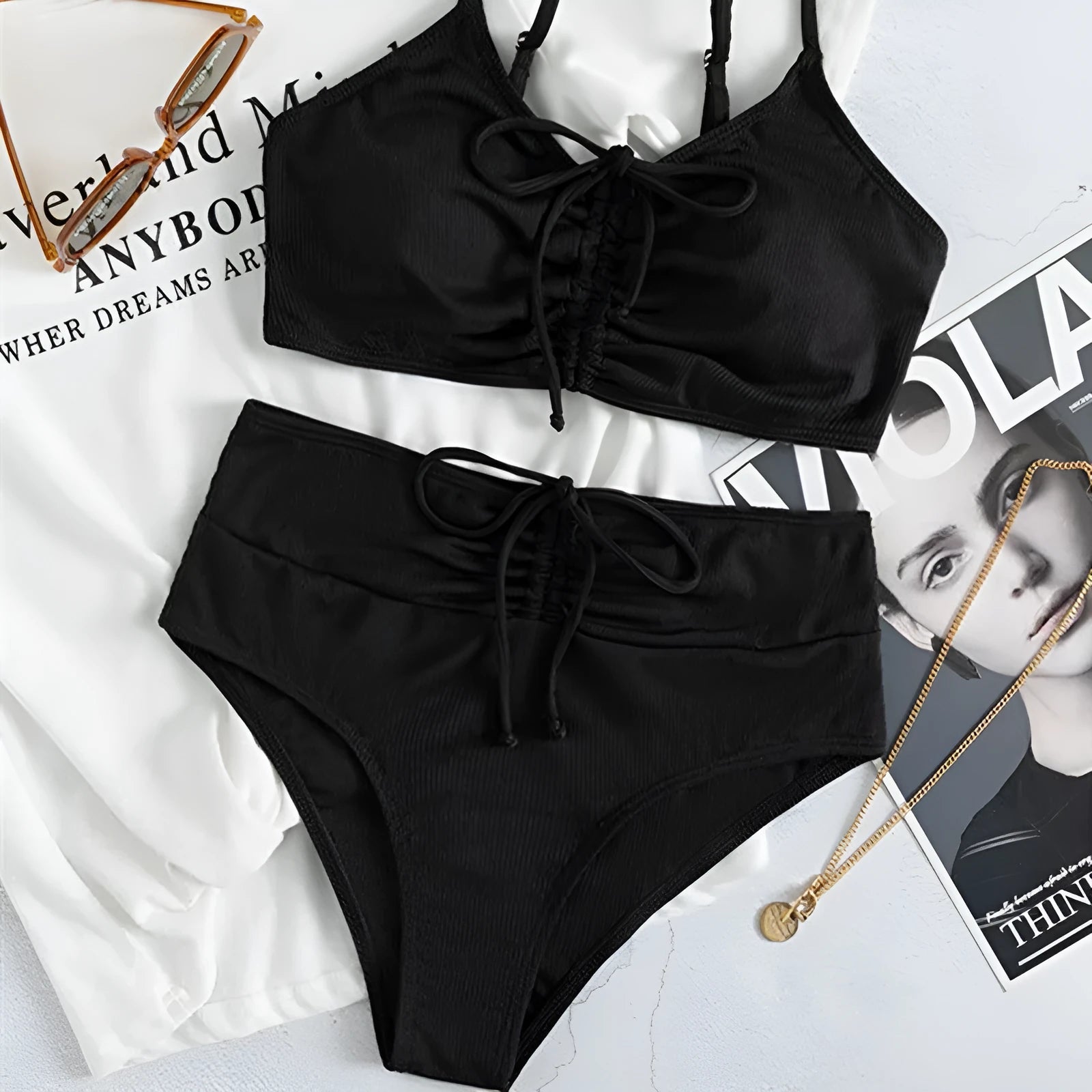 Black women's bikini with high waist and sling split design, shown as a two-piece set.