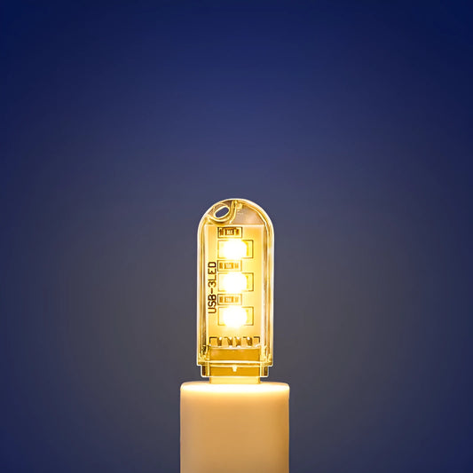 Small white USB LED baby night light showing warm and white light modes on a table.