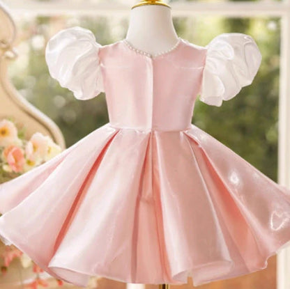 Girls pink puff sleeve princess dress with colour-coordinated design on hanger