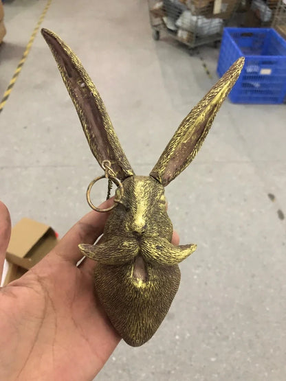 Antique bronze animal pendant showing bear design with synthetic resin construction