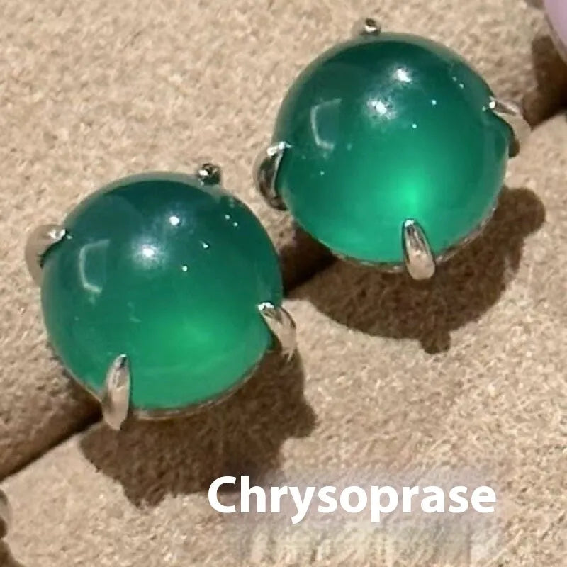 Close-up of a Chinese retro style stud earring with a round green chalcedony stone in a four-claw copper setting.
