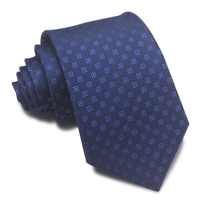 Close-up of a red and black striped jacquard weave tie with an arrow tip, showing texture.