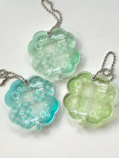Blue, green, and mint green four-leaf clover acrylic pendant keychain on a metal ring.