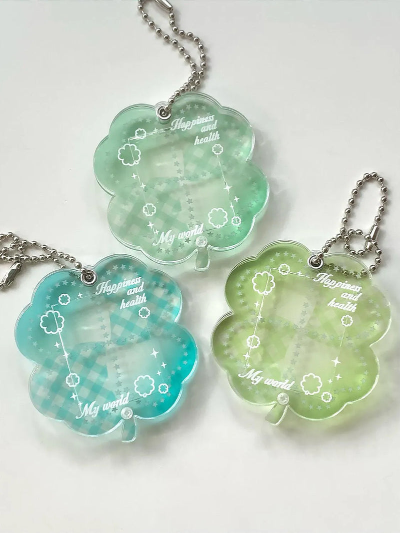 Mobile phone pendant keychain lanyard featuring a four-leaf clover acrylic charm in a choice of elegant blue, grass green, or mint green, designed as a creative decorative accessory for phones and keys