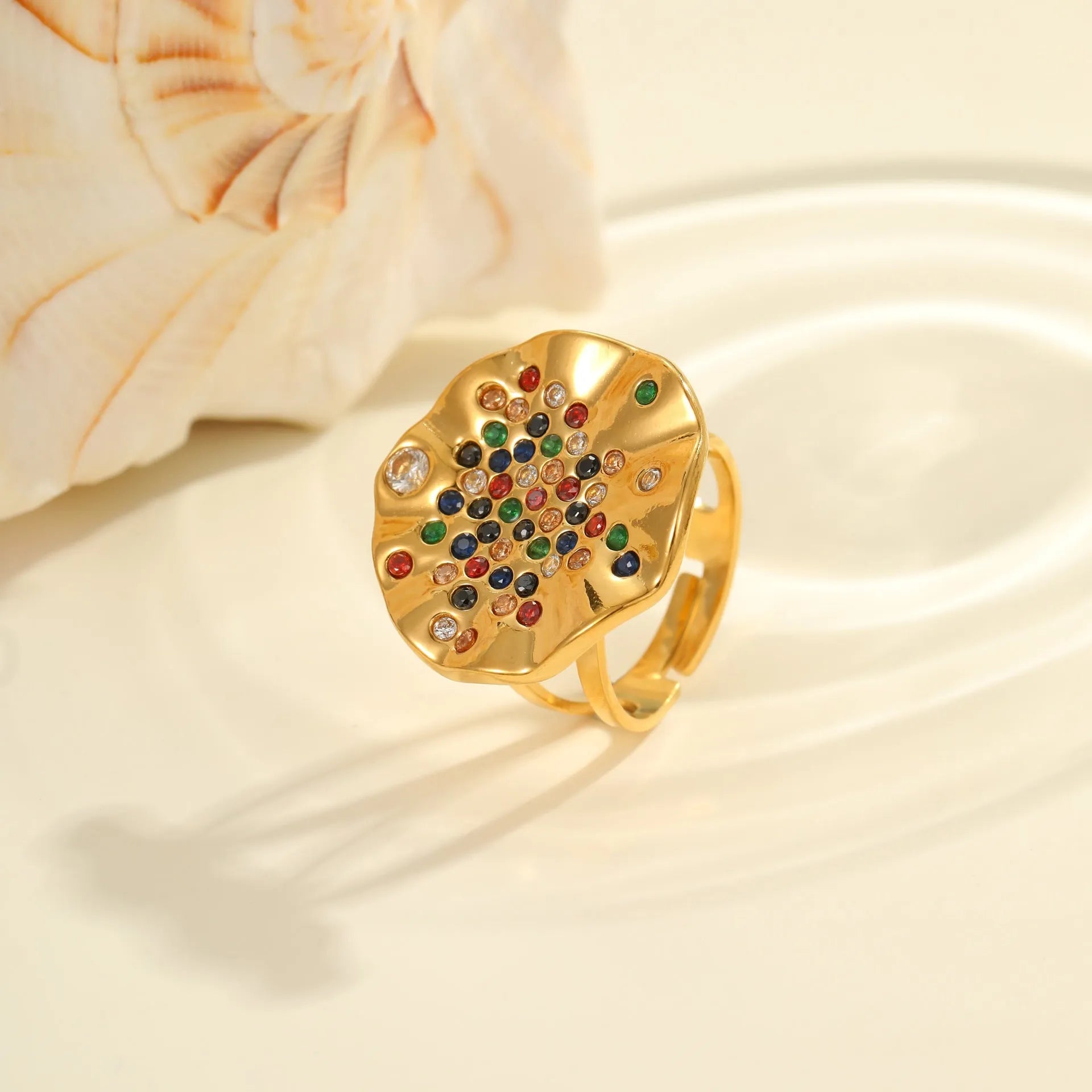 Pleated geometric open mouth ring made from stainless steel with colourful crystal inlay on a hand.