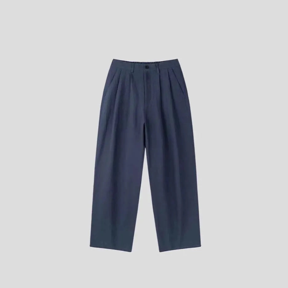 Men's apricot cotton linen trousers with elastic waistband and pencil leg opening on hanger