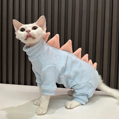Dinosaur costume on hairless Sphynx cat showing fleece material and decorative spikes
