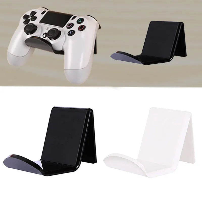 A universal black game controller mounting bracket shown installed on a wall.
