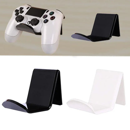 A universal black game controller mounting bracket shown installed on a wall.