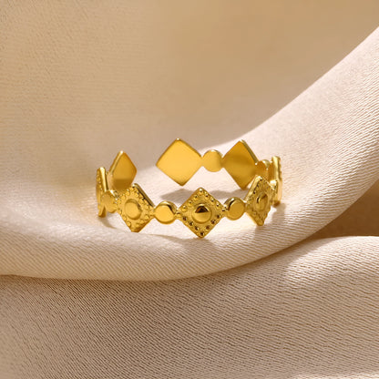 Gold tone geometric titanium steel women's ring with a small diamond accent on an adjustable band.