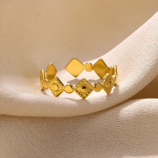 Gold tone geometric titanium steel women's ring with a small diamond accent on an adjustable band.