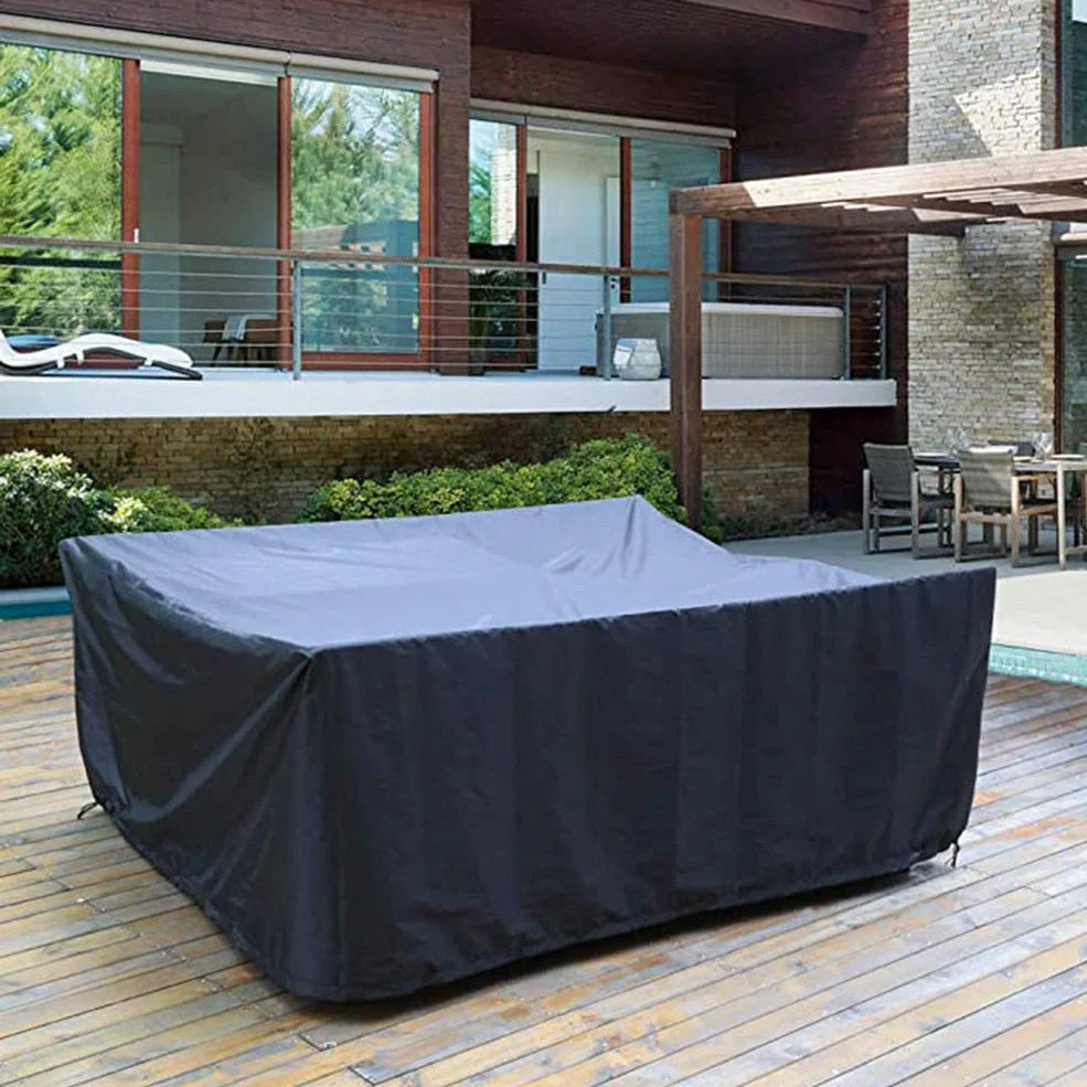 Waterproof furniture cover protecting outdoor table and chairs from rain with integrated storage bag