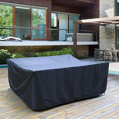 Waterproof furniture cover protecting outdoor table and chairs from rain with integrated storage bag
