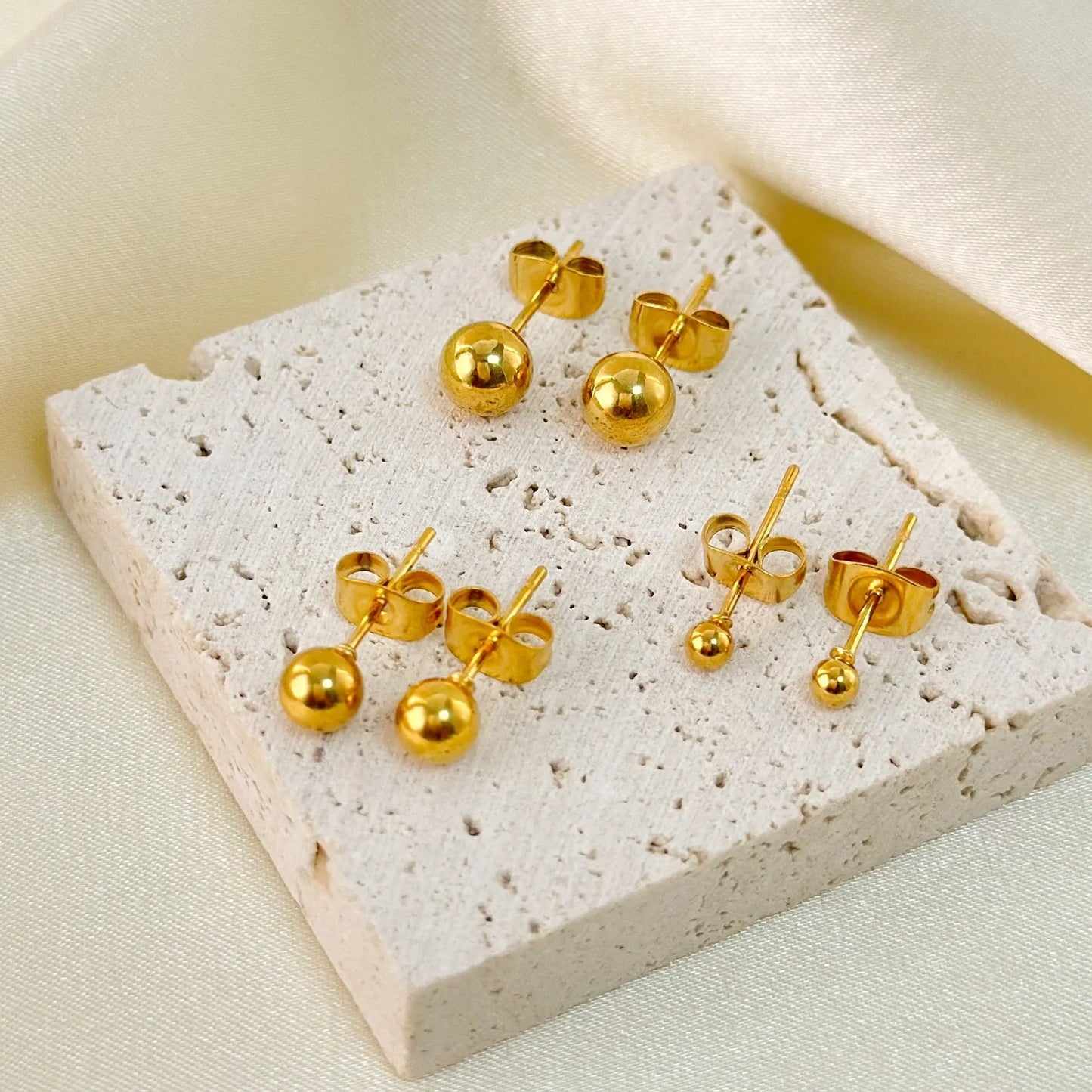 Stainless steel ball stud earrings with round geometric design in gold or silver finish
