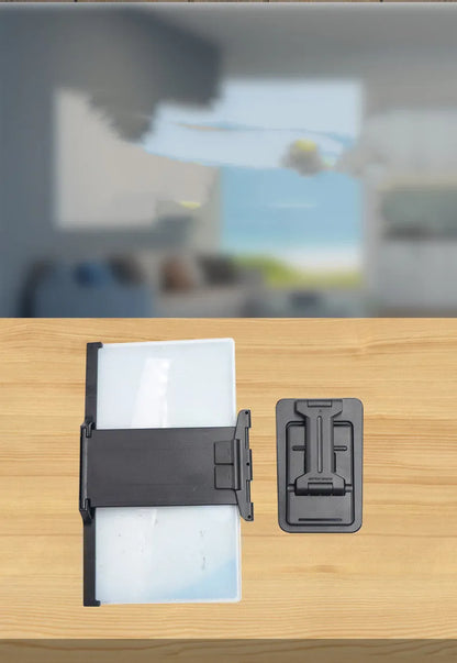 Black mobile phone screen amplifier with detachable holder, magnifying to 12 inches, folded for portability