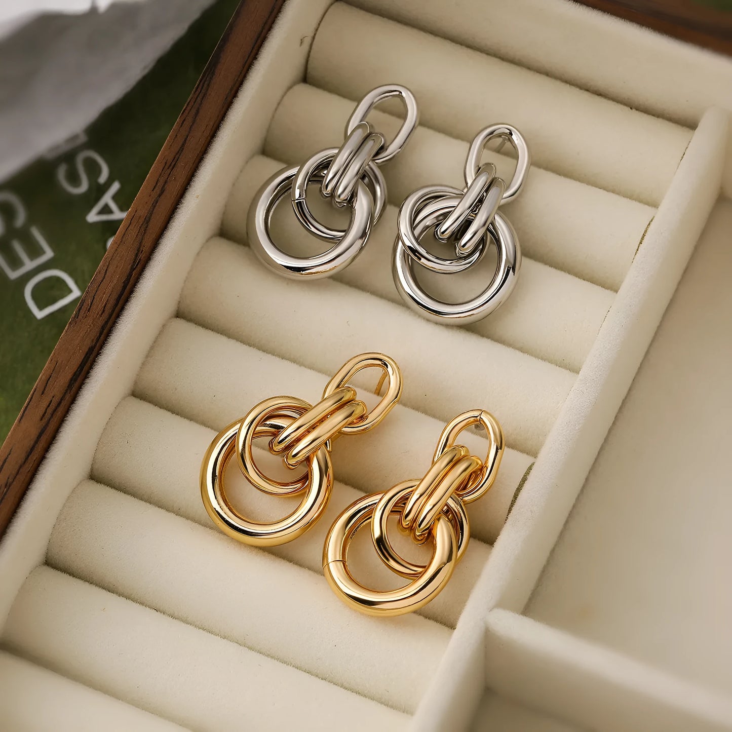 Geometric gold-coloured copper earrings with irregular asymmetric design