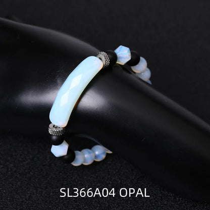 Handmade diamond-shaped cut black agate bracelet with fan-shaped details on a wrist.