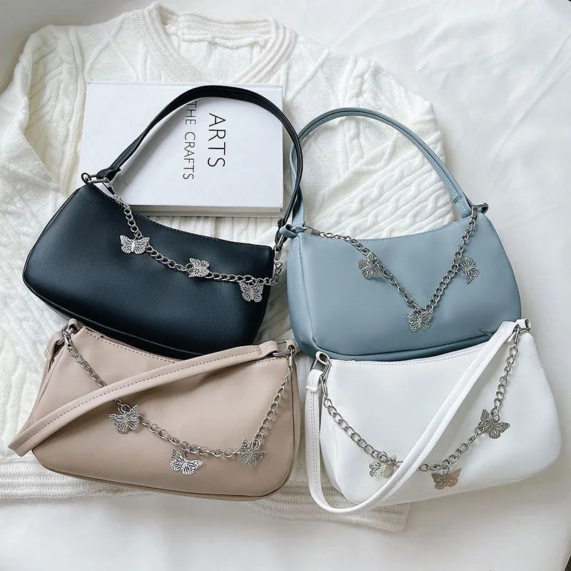 Women's black PU leather chain crossbody bag with butterfly clasp and structured square silhouette
