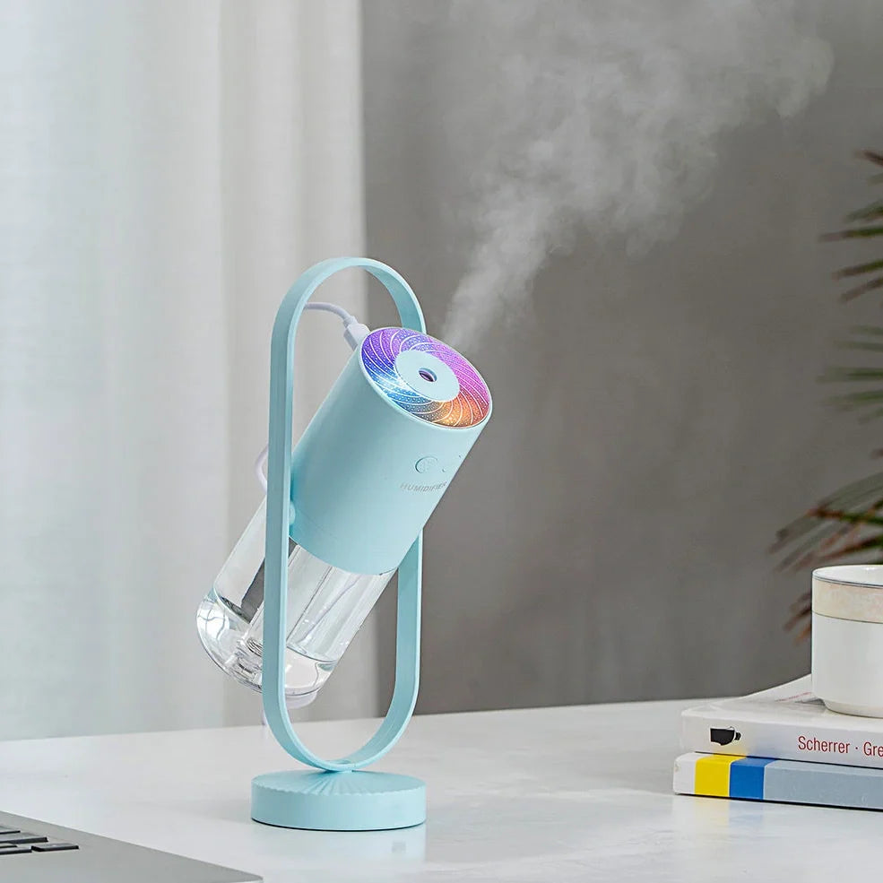 Portable USB humidifier with 200ml water tank in pink, blue, or white showing compact 70x66x213mm dimensions