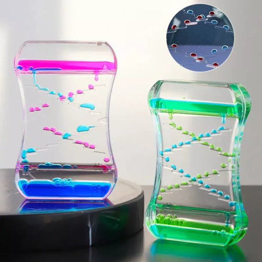 Creative Cruise Fluid Liquid Hourglass Timer with blue and pink liquid on desk