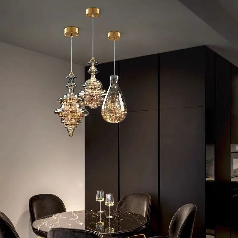 Modern adjustable glass droplight chandelier with LED lighting on a long suspension cable.