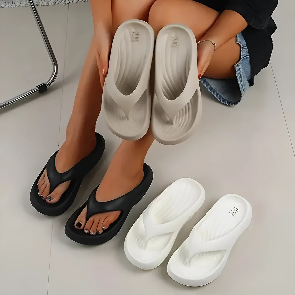 Women's black thick-soled EVA flip-flops with a non-slip pattern on the sole.