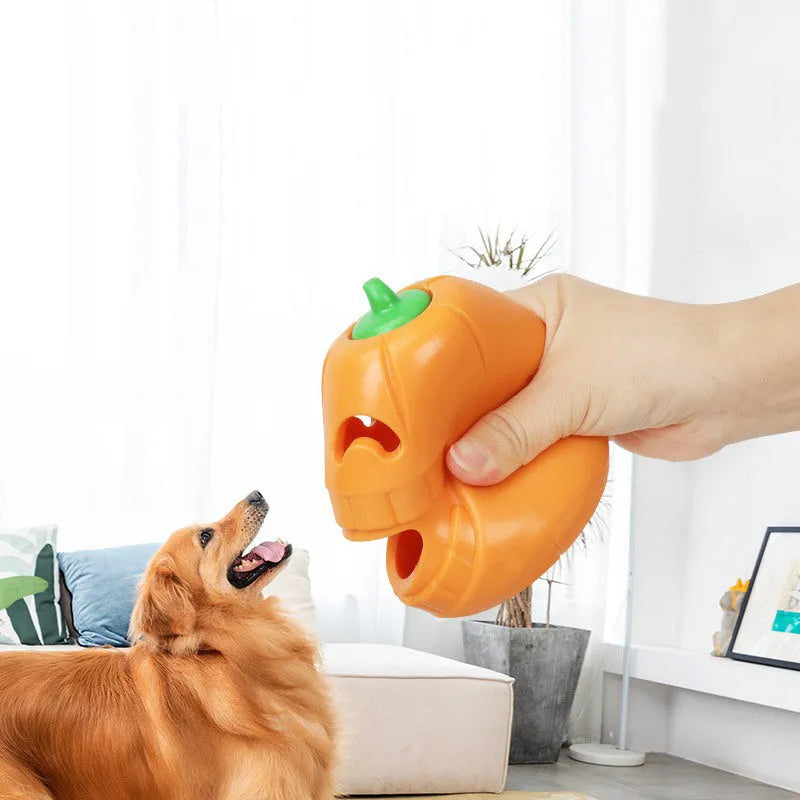 Halloween pumpkin-shaped dog chew toy with treat-dispensing funnel, made from orange thermoplastic rubber