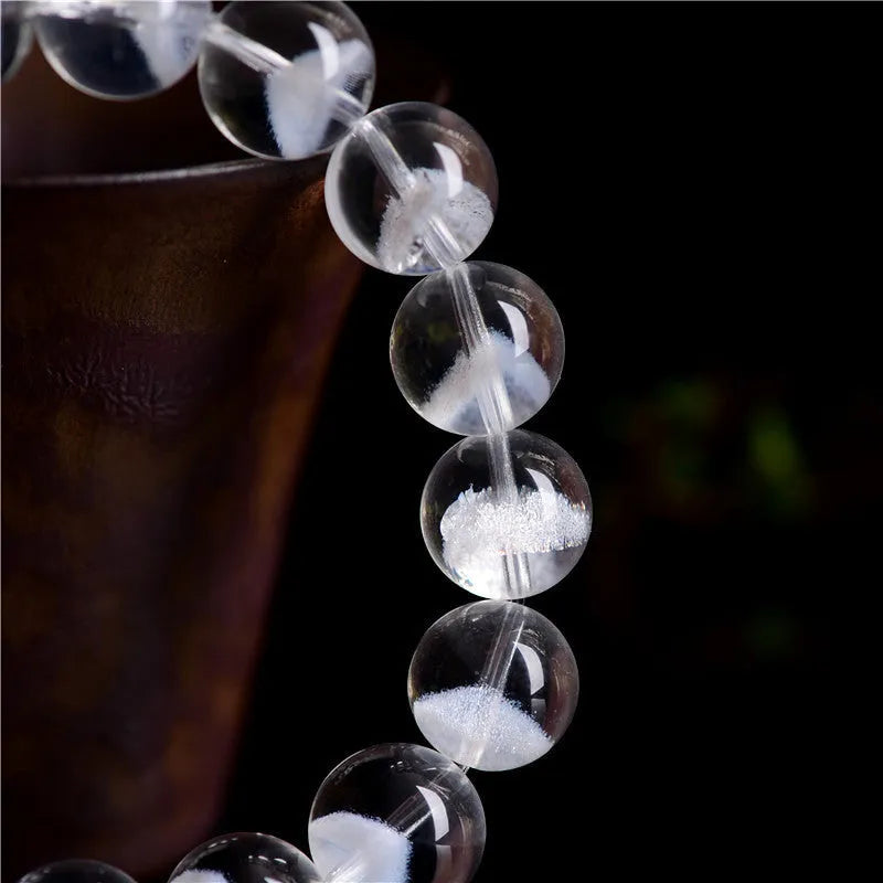 Women's original design bracelet with white crystal ghost pyramid beads and a ruyi decorative element.
