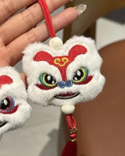 Blue and yellow Chinese style plush lion keychain ornament with star stone eyes and tassel.