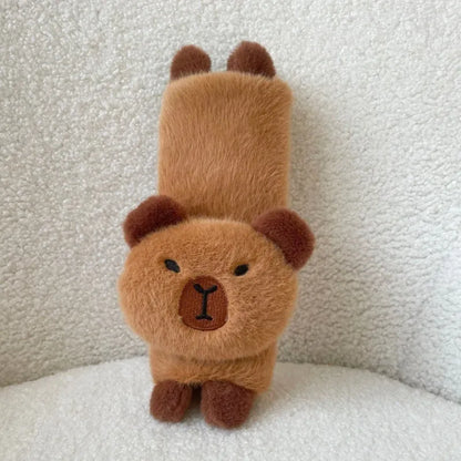 Khaki capybara car pillow in artificial plush with synthetic fibre filling, shown as a car neck pillow or shoulder cover.