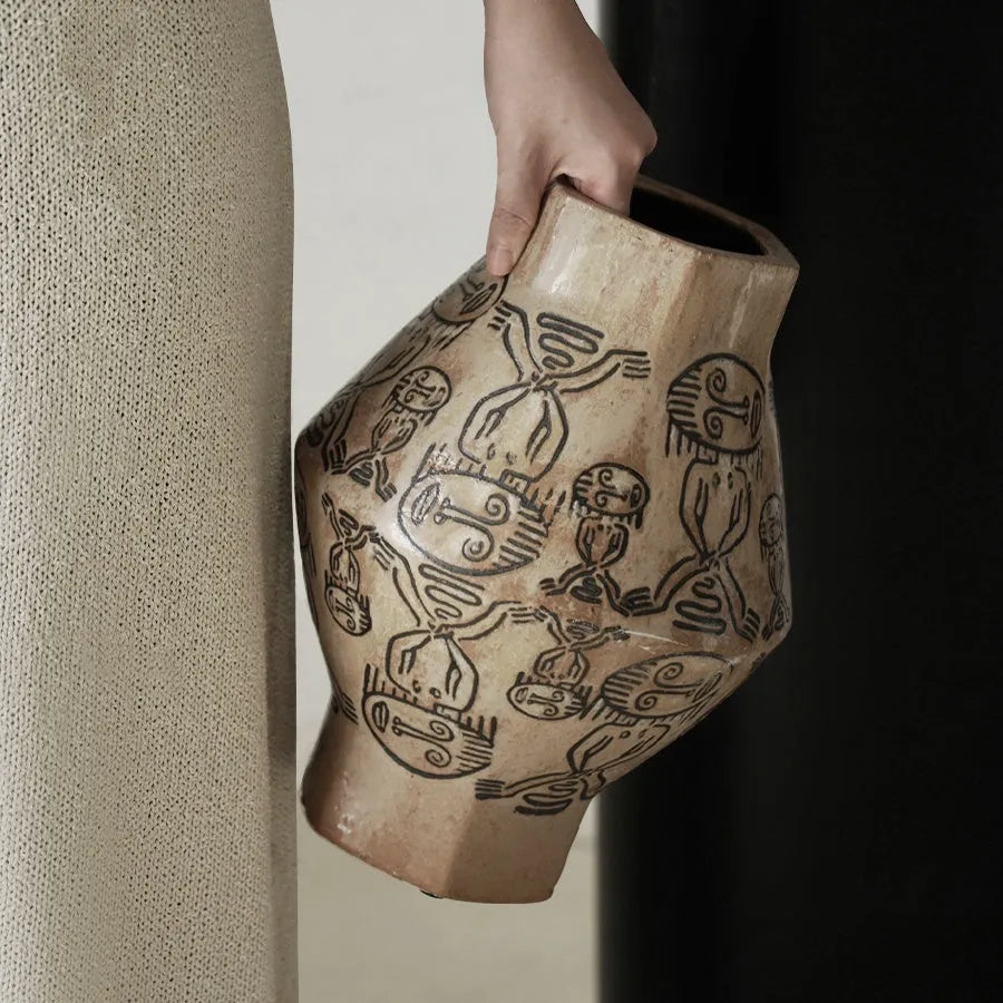Hand-painted ceramic vase with religious patterns and carved texture in cylindrical shape