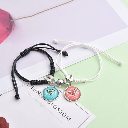 Magnetic suction couple bracelet pair in alloy with an electroplated finish, showing example designs like a crown and love lock.