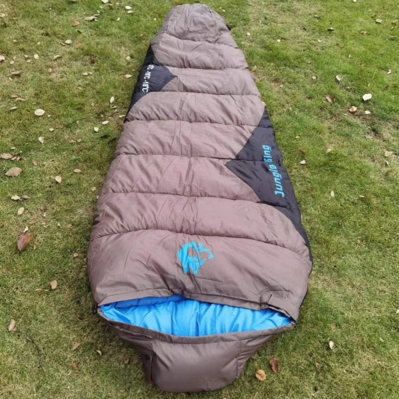 Outdoor mummy sleeping bag in army green with a compression sack, shown unrolled.