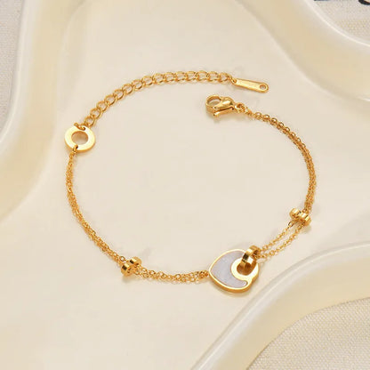 Stainless steel bracelet with double-layer heart design containing resin elements, shown on wrist