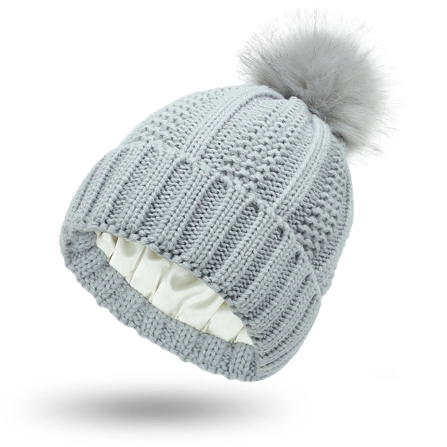 Wool knit beanie hat for women with faux fur pom pom and satin lining, shown in a wine red colour.