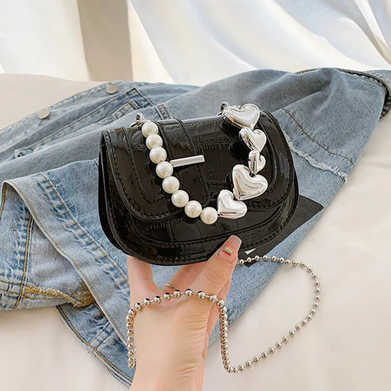 Laser Pearl Tote Saddle Girl Mini crossbody bag in black with sandwich pocket design and adjustable strap