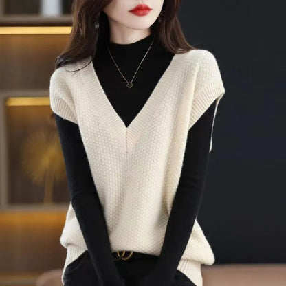 Women's creamy-white sleeveless knit vest with a raised 3D pattern, shown on a hanger.
