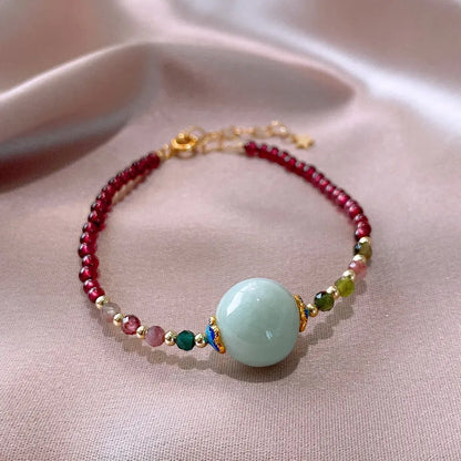 Aquamarine coloured drop shape tourmaline bracelet with garnet electroplated finish