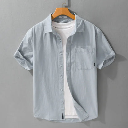Men's loose fit pure cotton short sleeve shirt in cardigan style, shown in light blue.