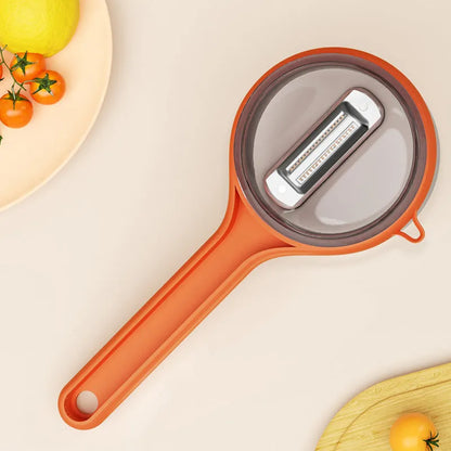 Light green kitchen peeler with an integrated storage bucket for collecting fruit and vegetable peel.