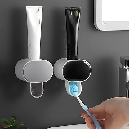 Black wall mounted automatic toothpaste dispenser with squeeze mechanism and dustproof toothbrush storage