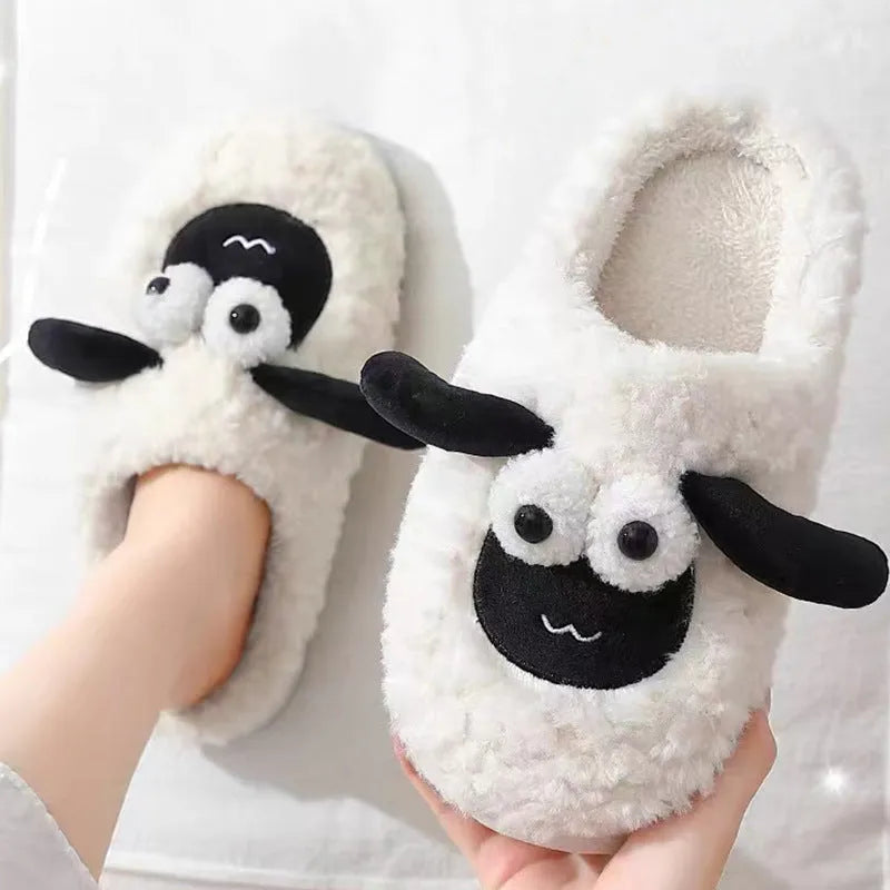 Brown suede slip-on slippers with thermal cotton body and sewn PVC sole on a wooden floor.