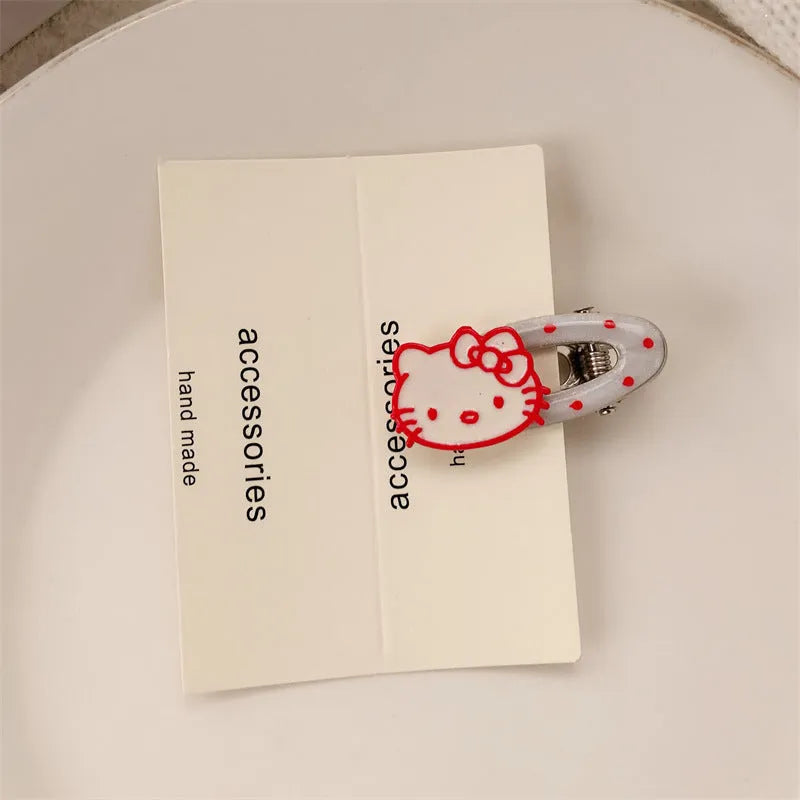 Red plastic hair clip with a 3D love heart and dots on a willow leaf-shaped base.